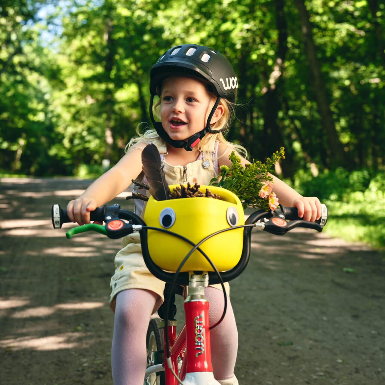 image of a little on a bike with a woomp pop basket in a campaign mood